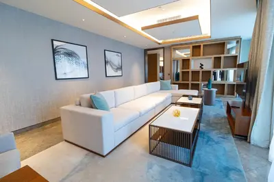 a living room with a white couch and a table at ADDRESS Residences Dubai Opera at Downtown in Dubai