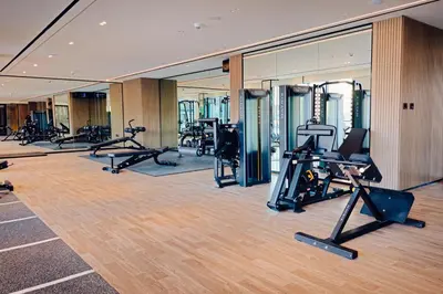 a gym with treadmills and cardio equipment in a building at 1BR Cozy and NEW brand JVC in Dubai