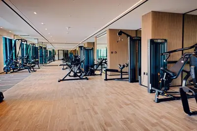 a gym with a row of treadmills and machines at 1BR Cozy and NEW brand JVC in Dubai