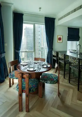 a dining room with a table and chairs and a window at Unique JBR Gem - Full Sea View - Designer's Choice - 5 min walk from JBR Beach in Dubai