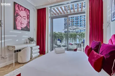a bedroom with a large bed and a large window at bnbmehomes - Oxford Terraces in Dubai