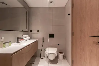 a bathroom with a toilet and a sink at HAVN - New Studio Business Bay, Burj Khalifa View in Dubai