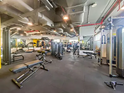 a gym with several treadmills and cardio machines at Silkhaus Cozy Studio at Sky Gardens-Heart of DIFC in Dubai