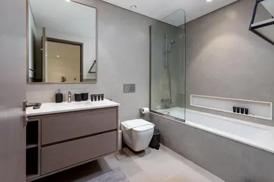 a bathroom with a toilet and a sink and a shower at Brand New 1BR Apt in Grande Residence, Downtown Dubai - Allsopp & Allsopp in Dubai