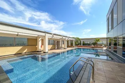 a large swimming pool next to a building at Silkhaus Sky Gardens at Homestyle Studio in DIFC in Dubai