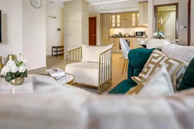 a living room with a couch and a table at Durrani Homes - Azure 2BR with Burj Khalifa and Fountain View in Dubai