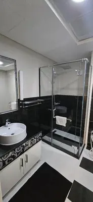 a bathroom with a glass shower and a sink at Superb 1 BR apt next to Burj Khalifa and Dubai mall in Dubai