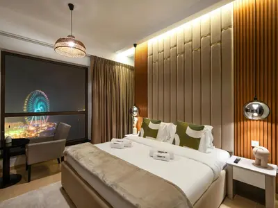 a hotel room with a large bed and a desk at WonderfulStay At JBR - Luxury Dubai Eye View Living - Beach Access - Brand New Luxury Apartments in Dubai