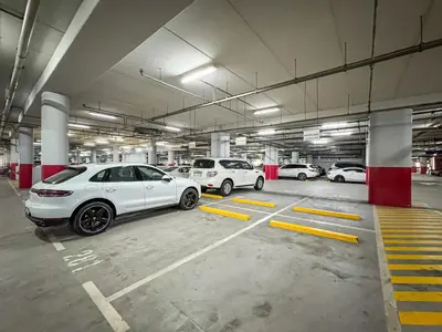 a group of cars parked in a parking garage at Savis Home Oceanfront Serenity and Marina Views in Dubai