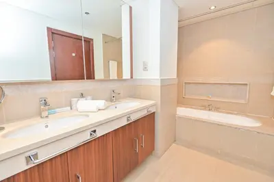 a bathroom with two sinks and a large mirror at Burj Vista 2BR Luxurious Apartment with Direct Access to Dubai Mall in Dubai