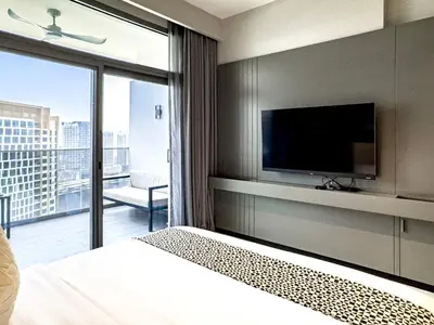 a bedroom with a bed and a tv and a balcony at Select Stay-Cozy Studio in MAG 318 with Canal View in Dubai