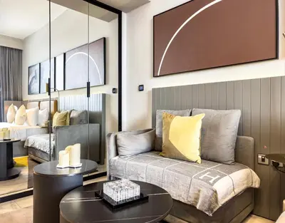 a living room with a couch and a table at Select Stay-Cozy Studio in MAG 318 with Canal View in Dubai
