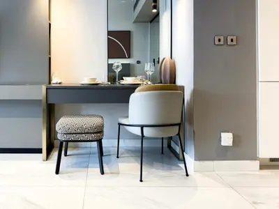 a dining room with a table and a chair at Select Stay-Cozy Studio in MAG 318 with Canal View in Dubai