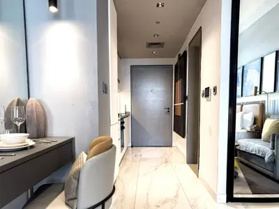 a hallway with a dining room and a living room at Select Stay-Cozy Studio in MAG 318 with Canal View in Dubai