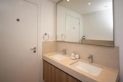 a bathroom with two sinks and a large mirror at Apartment in Downtown Dubai in Dubai
