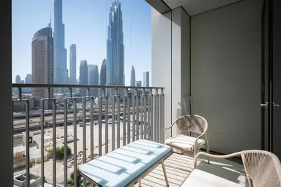 a balcony with two chairs and a view of a city at Apartment in Downtown Dubai in Dubai