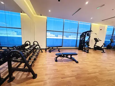 a gym with treadmills and exercise equipment in a building at Meydan Marvel Sleek 1-Bedroom Home in Prime Views with Luxe Finishes! by Petals Holiday Homes in Dubai