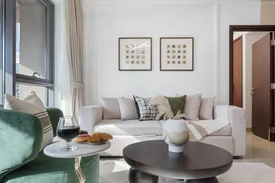 a living room with a couch and a table at The Boulevard Suite Luxury Burj Khalifa View - Downtown in Dubai