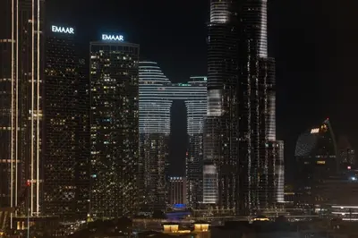 a view of a city skyline at night at The Boulevard Suite Luxury Burj Khalifa View - Downtown in Dubai