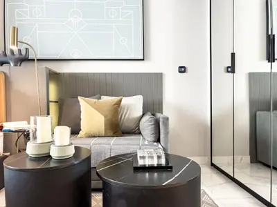 a living room with a couch and a table at Select Stay-Studio in MAG 318 - Minutes to Dubai Mall in Dubai
