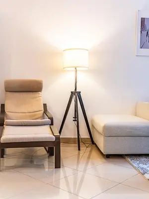 a living room with a chair and a lamp at Luxury Modern 1BR-Concorde Tower 1-JLT in Dubai