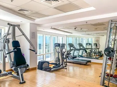 a gym with several treadmills and elliptical machines at Luxury Modern 1BR-Concorde Tower 1-JLT in Dubai