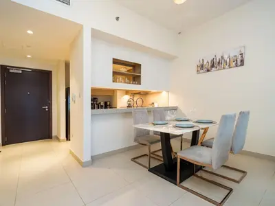 a kitchen and dining room with a table and chairs at Tranquil 1 Bedroom Dubai Hills Escape in Dubai