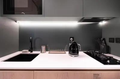 a kitchen with a black and white counter top at Modern Studio, Burj Views - Business Travelers in Dubai