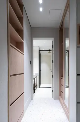 a hallway with wooden doors and a hallway leading into aartmentartment at Modern Studio, Burj Views - Business Travelers in Dubai