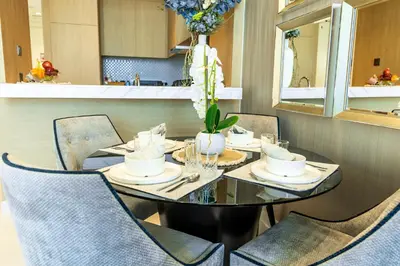 a dining room with a table and chairs at 2 Bedrooms with Iconic Burj Khalifa Views Stay in Dubai