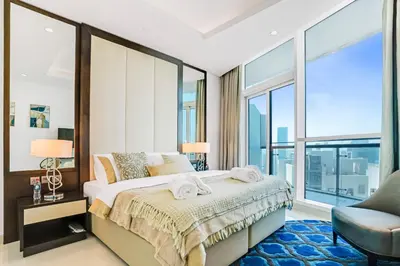 a bedroom with a bed and a large window at 2 Bedrooms with Iconic Burj Khalifa Views Stay in Dubai