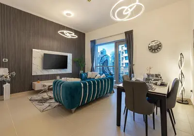 a living room with a couch and a table and a television at Luxurious one bedroom Apartment with Burj Khalifa View in Dubai