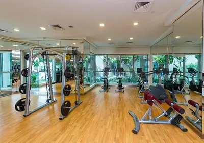 a gym with several treadmills and elliptical machines at Luxurious one bedroom Apartment with Burj Khalifa View in Dubai