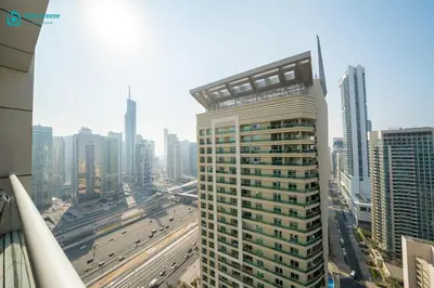 a tall building in a city with traffic at Blue Breeze - Modern Apt with Partial Marina Views & Balcony in Dubai