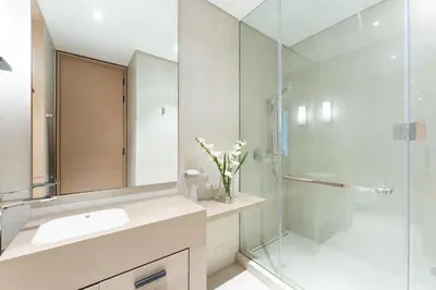 a bathroom with a sink and a glass shower at Luxury 2 Bedroom Apartment with Breathtaking Dubai in Dubai