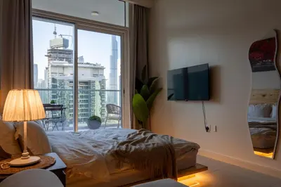 a bedroom with a bed and a large window at japanDXB Burj Khalifa view - 4min Dubai Mall in Dubai
