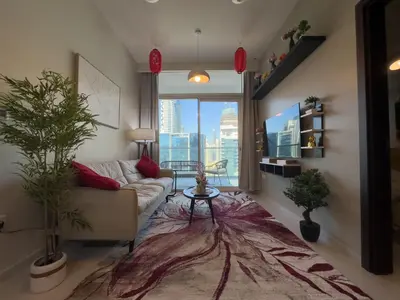 a living room with a couch and a large window at japanDXB Burj Khalifa view - 4min Dubai Mall in Dubai