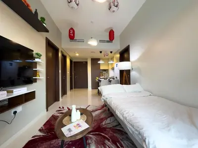 a hotel room with two beds and a tv at japanDXB Burj Khalifa view - 4min Dubai Mall in Dubai
