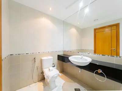a bathroom with a toilet and a sink at SettlerHomes - FIRST CLASS JBR Stay On High-Floor in Dubai