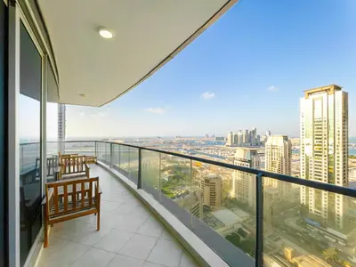 a balcony with a view of a city at SettlerHomes - FIRST CLASS JBR Stay On High-Floor in Dubai
