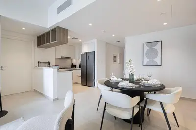 a kitchen and dining room with a table and chairs at Full Burj view & Direct Access to Dubai Mall in Dubai
