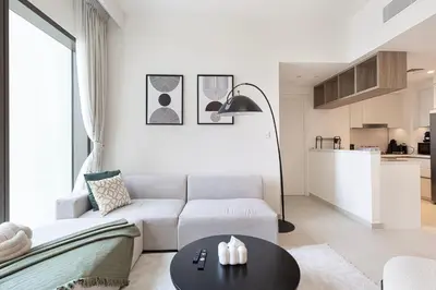 a living room with a white couch and a table at Full Burj view & Direct Access to Dubai Mall in Dubai