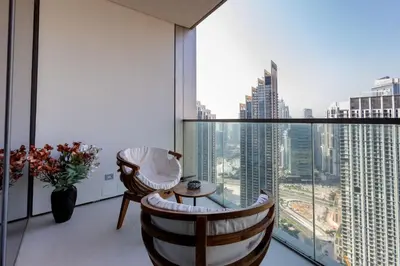 a room with a large window with a table and chairs at Near Burj Khalifa - 1BR Apartment in Grande Residence, Downtown - Allsopp & Allsopp in Dubai
