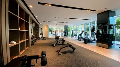 a gym with treadmills and exercise equipment in a building at Near Burj Khalifa - 1BR Apartment in Grande Residence, Downtown - Allsopp & Allsopp in Dubai