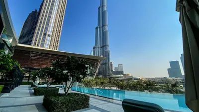 a view of a city skyline from a hotel balcony at Near Burj Khalifa - 1BR Apartment in Grande Residence, Downtown - Allsopp & Allsopp in Dubai