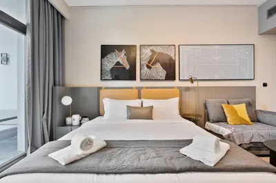 a bedroom with a large white bed and a couch at Upmarket Studio in Business Bay with a Gym and Pool in Dubai