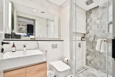a bathroom with a sink and a toilet and a shower at Upmarket Studio in Business Bay with a Gym and Pool in Dubai