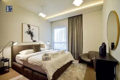 a bedroom with a large bed and a mirror at Luxury Escapes - Three-Bedroom Apartment with Lake View in Dubai