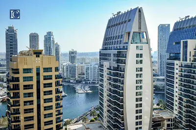 a view of a city with tall buildings and a river at Luxury Escapes - Three-Bedroom Apartment with Lake View in Dubai