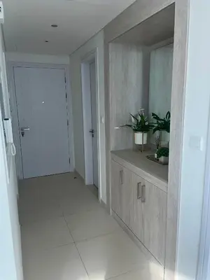 a hallway with a sink and a mirror at Great one bedroom apartment with infinity pool in Dubai